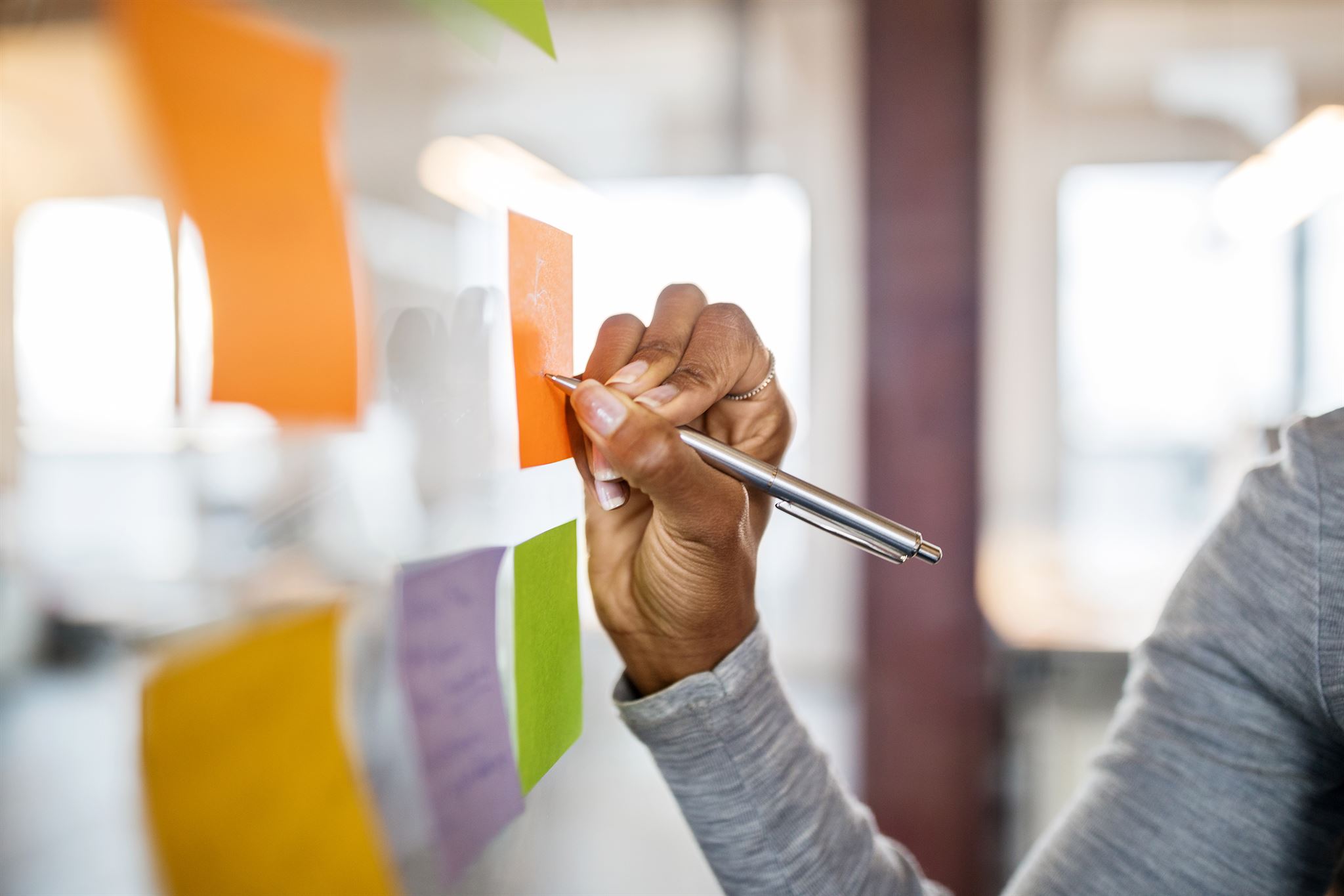 A-person-writing-on-sticky-notes