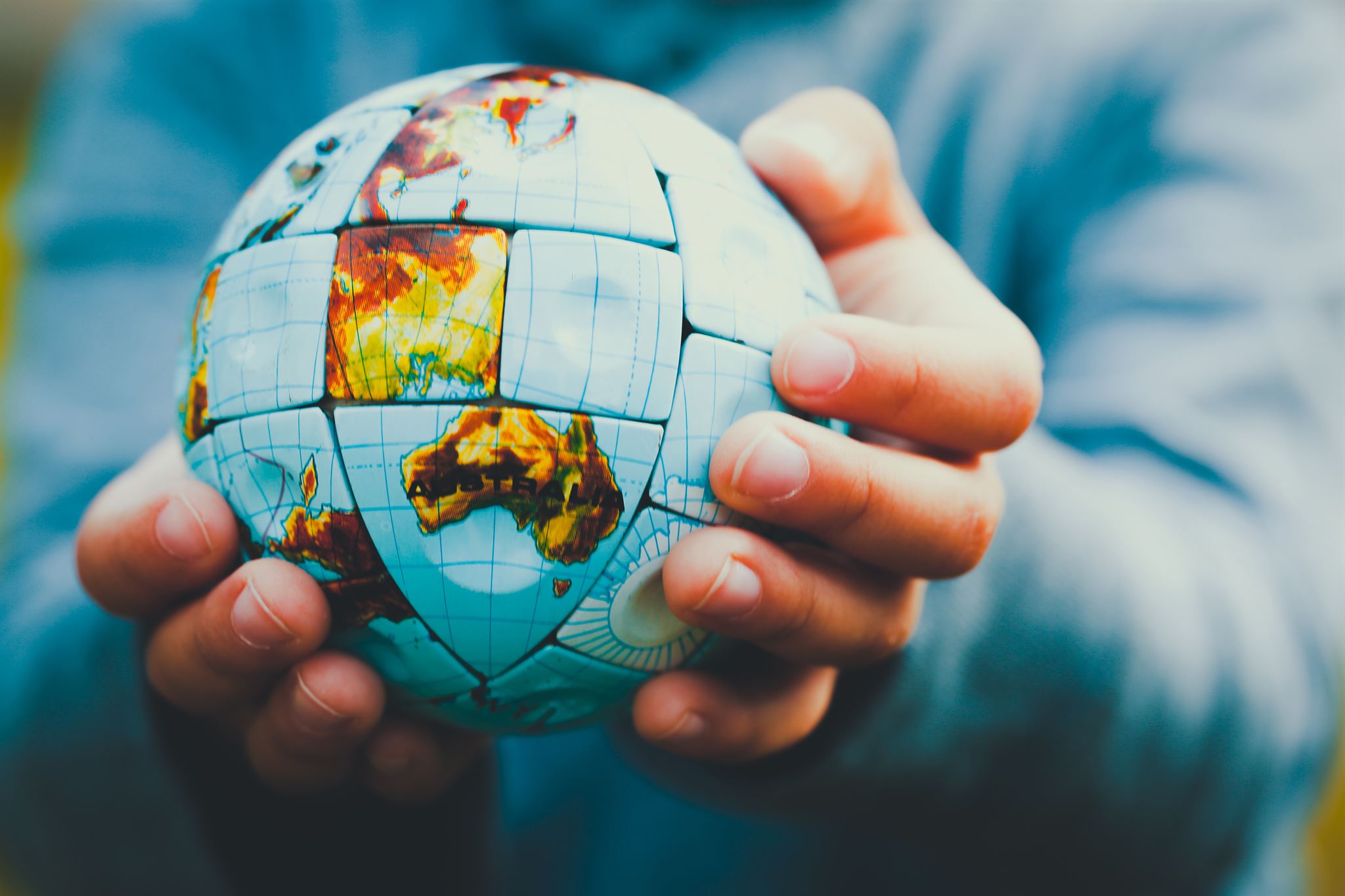 Person-holding-globe-jigsaw